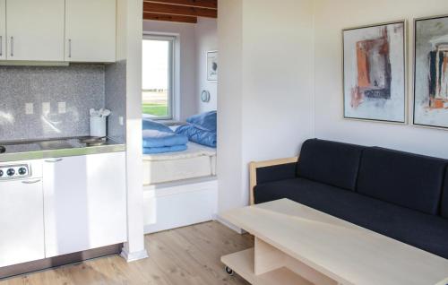 a living room with a couch and a kitchen at Studio Apartment In Logumkloster in Løgumkloster