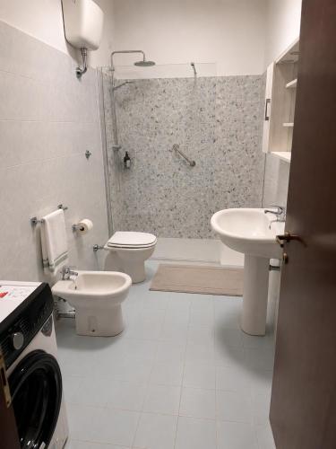 a bathroom with a shower and a toilet and a sink at BluTerra home in Porto San Giorgio
