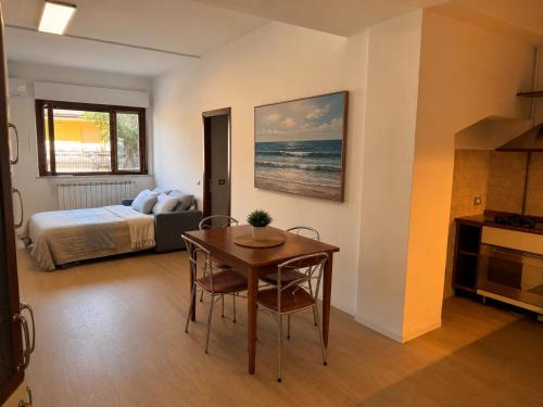 a bedroom with a table and a bed and a table and chairs at BluTerra home in Porto San Giorgio