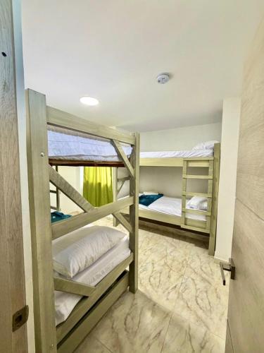 a bunk bed room with two bunk beds at Hostal La Marina in Santa Marta