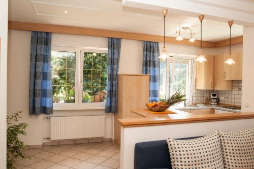 a kitchen with blue curtains and a counter top at Residence Wiesenheim in Trodena