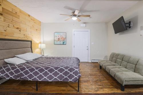 a bedroom with a bed and a couch at Rustic Private Studio Near Downtown Worcester in Worcester
