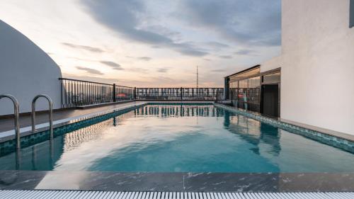 a swimming pool on the roof of a building at MT Collection Legacy Hotel Ninh Binh - Near Hoa Lu Ancient Town with Rooftop Pool in Ninh Binh