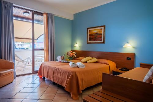 Postel nebo postele na pokoji v ubytování Hotel Bacco