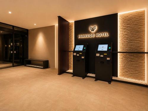 a hotel lobby with two atm machines at ホテル翔 Sapporo PARKSIDE HOTEL in Sapporo