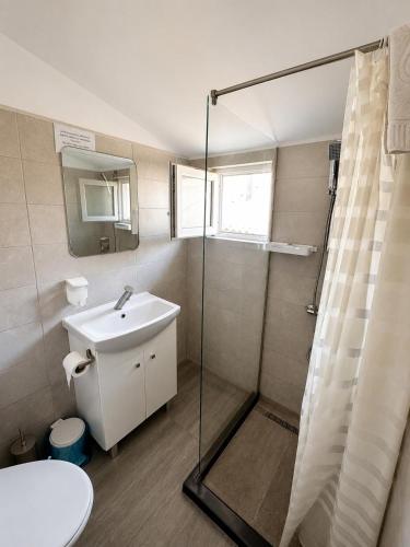 a bathroom with a sink and a shower at Paradox Cantacuzino in Eforie Sud