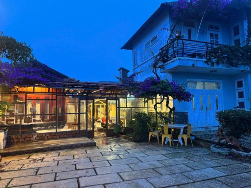 a house with a patio and a table and chairs at Mây inn' Cầu Đất - Homestay in Xuân Trường