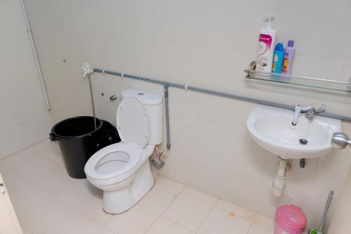 a bathroom with a toilet and a sink at Deeja Homestay Kuantan in Kuantan