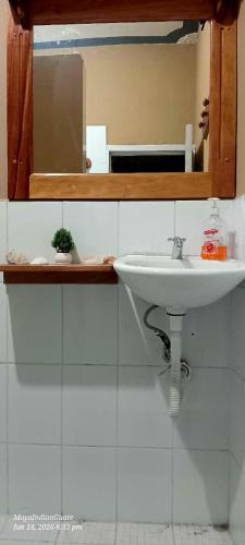 a bathroom with a sink and a mirror at Hostel New Brothers in Panajachel