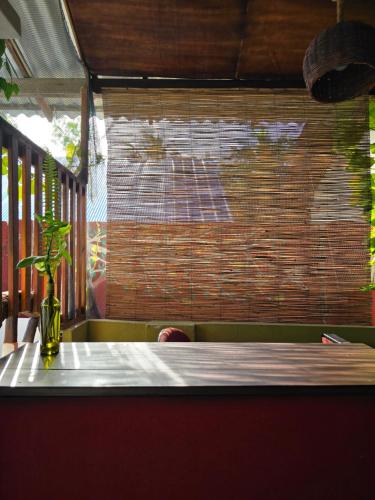 a table with a vase sitting on top at Cozy Sand Beach Hotel in Arugam Bay
