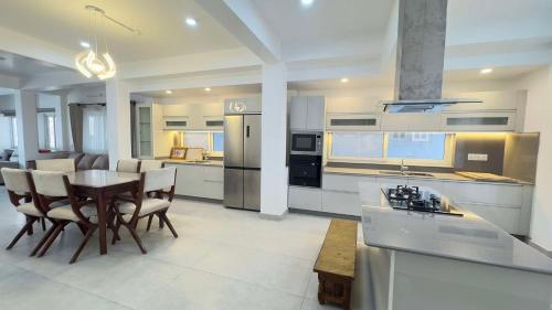 a large kitchen with a table and chairs in it at Square Accommodation Rudra kunj in Pokhara