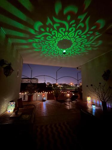 a living room with a green chandelier on the ceiling at B&BMagicHouse in Novara