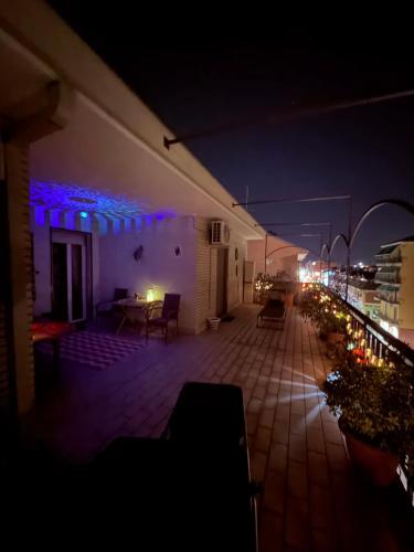 a balcony of a building at night with lights at B&BMagicHouse in Novara