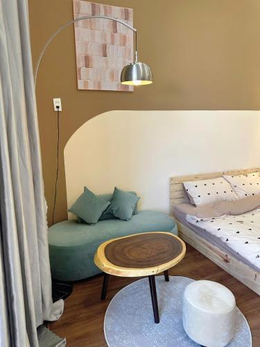 a living room with a couch and a table at Phố Homestay Phan Thiết in Phan Thiet