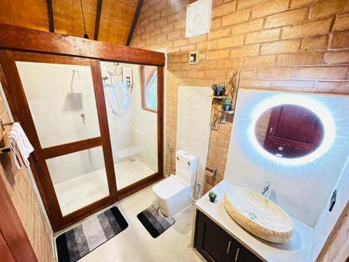 a bathroom with a sink and a shower and a toilet at Ima Villa Sigiriya in Sigiriya
