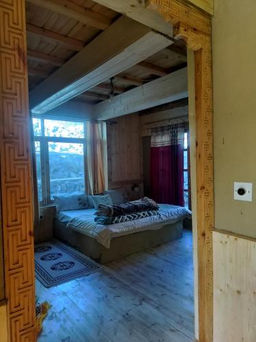 a bedroom with a bed in a room with a window at Aama Homestay in Tabo