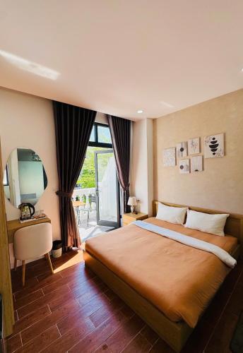 a bedroom with a large bed and a television at StayLa Homestay Grand World Phu Quoc in Phú Quốc