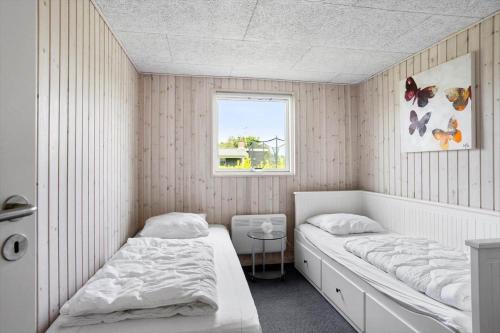 a bedroom with two beds and a window at FY134-Middelfart-Antaresvej-4 in Middelfart