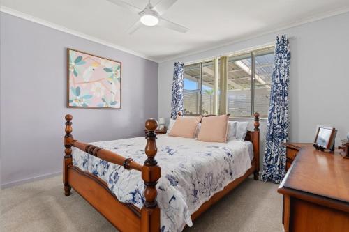 a bedroom with a bed and a window at Blue Meadow - Pet Friendly in Evans Head