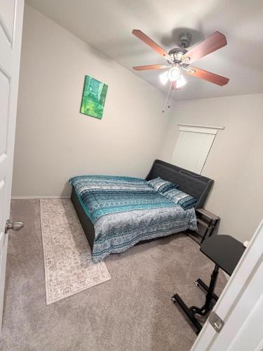 a bedroom with a bed and a ceiling fan at Cozy Retreat in San Antonio
