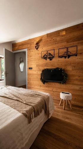 a bedroom with a bed and a wooden wall at mansarda roulette in Saint Vincent