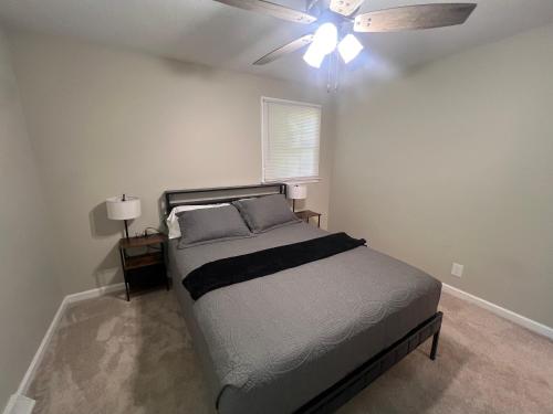 a bedroom with a bed and a ceiling fan at Greystone Ranch Pet Friendly in Clarksville