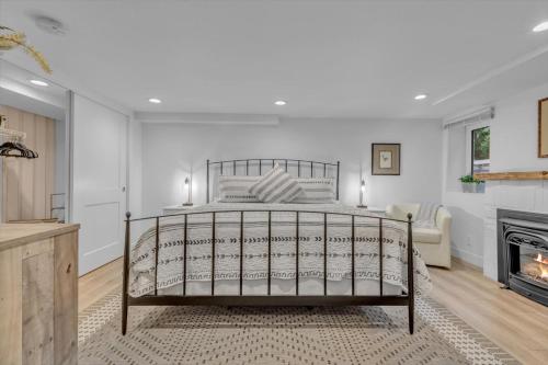 a bedroom with a bed and a fireplace at Charming Washington Park Getaway in Denver