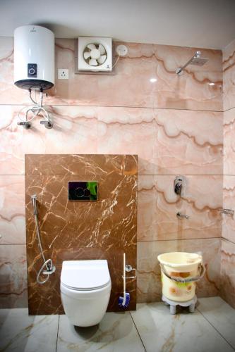 a bathroom with a toilet and a sink at Serene Vista Dharamshala in Dharmsāla