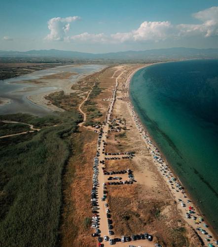an aerial view of a beach with a bunch of cars at Filemial House in Agios Mamas