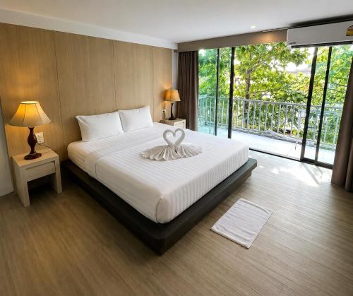 a bedroom with a bed with two swans on it at A Plus Deluxe Hotel in Ko Lipe