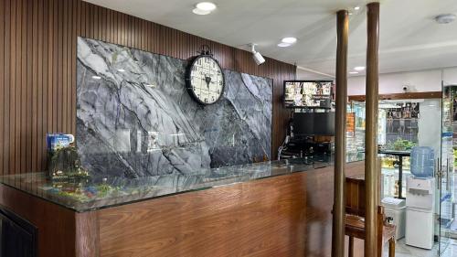 a bar with a clock on the wall at Hotel Lleras # 1 in Medellín