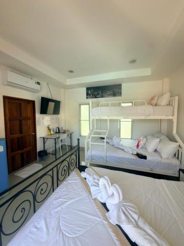 a bedroom with two bunk beds with towels on the floor at Home Hakim in Cha Am