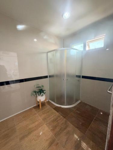 a bathroom with a shower with a potted plant in it at Home Hakim in Cha Am