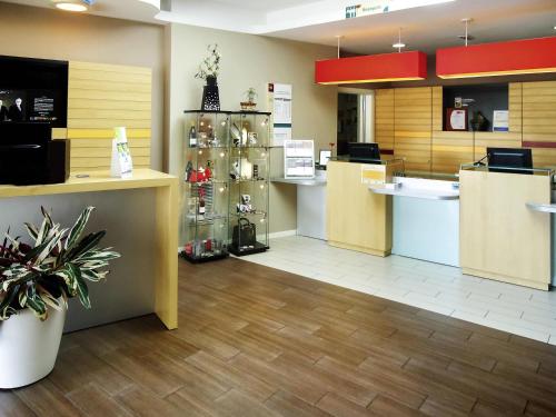 a store lobby with a counter and a kitchen at Ibis Girona in Girona
