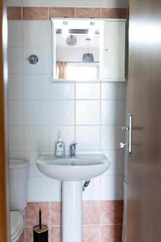 a bathroom with a sink and a toilet at Elia mini suite 2 in Larisa