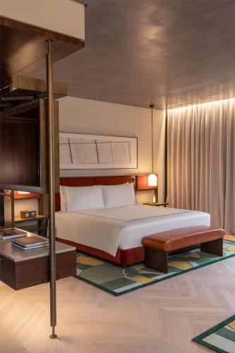 a bedroom with a large bed and a platform bed at Thompson Rome, By Hyatt in Rome