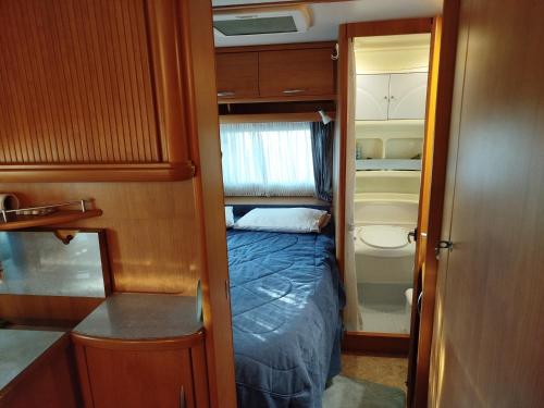 a small room with a bed and a toilet at DamAnda mare in Nea Potidaea