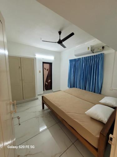 a bedroom with a large bed and a ceiling fan at Kasi Heritage Home Near Sree Padmanabha Swami Temple 800m in Trivandrum