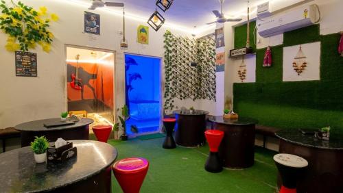 a room with tables and chairs and a blue door at Rajputana cafe and restaurant in Dausa