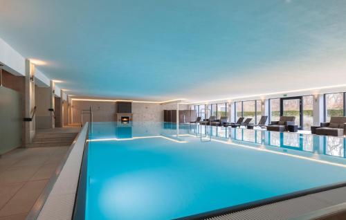 a swimming pool in a hotel with blue lighting at Skipper in Binz