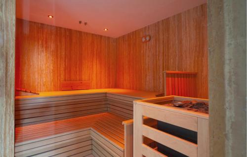 a sauna with wood paneled walls and a wooden floor at Skipper in Binz