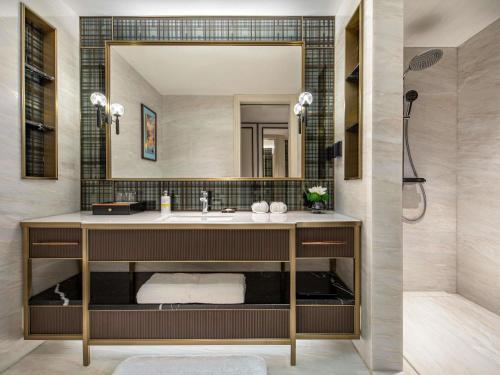 a bathroom with a sink and a mirror at Pullman Beijing South - Newly Renovated in Beijing