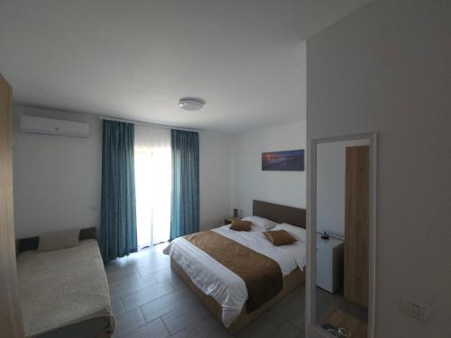 a hotel room with a bed and a mirror at Vila La Fernando in Tuzla
