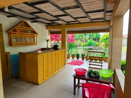 a kitchen with a counter and a table and chairs at Tamu Homestay in Jhawāni