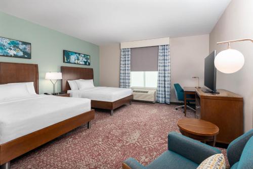 a hotel room with two beds and a desk at Hilton Garden Inn Wayne in Wayne