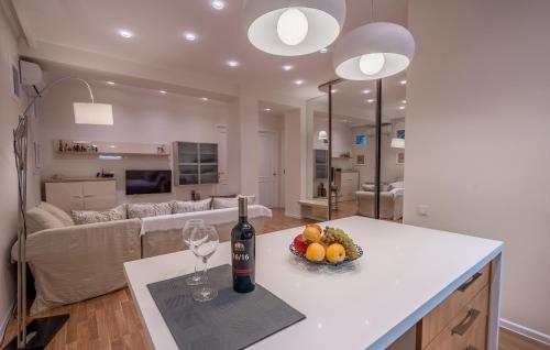 a kitchen with a bottle of wine and a bowl of fruit at Hyacinth House in Tbilisi City