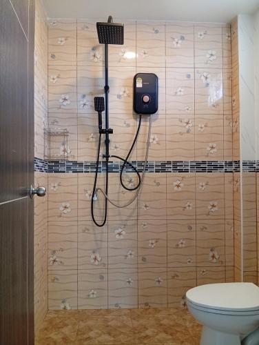 a bathroom with a shower and a toilet in a room at Stylish 1BR Retreat with Workspace & Hammock in Hinkong