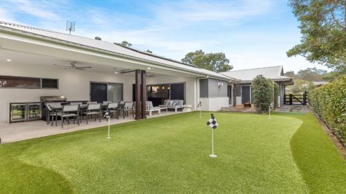 an image of a house with a yard with putting greens at Alkira at The Vintage in Pokolbin