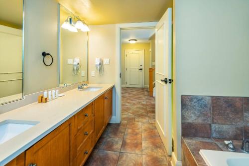 a bathroom with two sinks and a large mirror at Calabogie Peaks Resort, an Ascend Collection Hotel in Calabogie