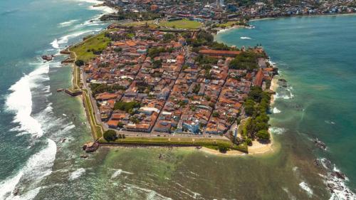 an aerial view of a town on the beach at Caritas Rest in Galle